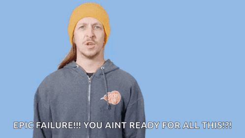 A Man In A Yellow Beanie Is Pointing At His Head With The Words " You Had One Job " Written Above Him GIF