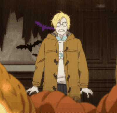 A Man In A Yellow Coat Stands In Front Of A Wall With Bats Flying In The Background GIF