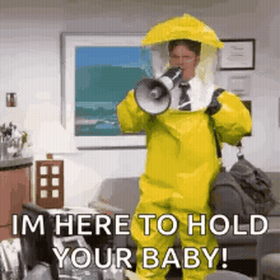 A Man In A Yellow Hazmat Suit Is Holding A Megaphone And Shouting . GIF