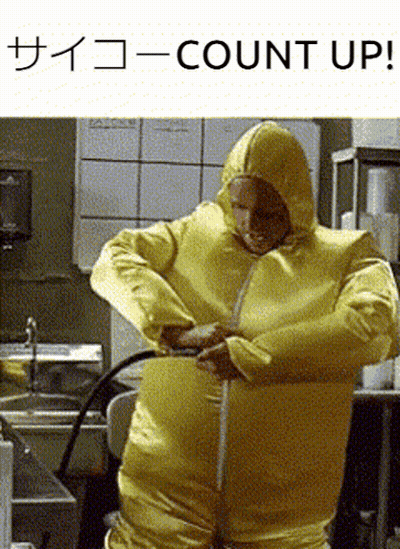 A Man In A Yellow Hazmat Suit Is Measuring His Waist With A Tape Measure GIF