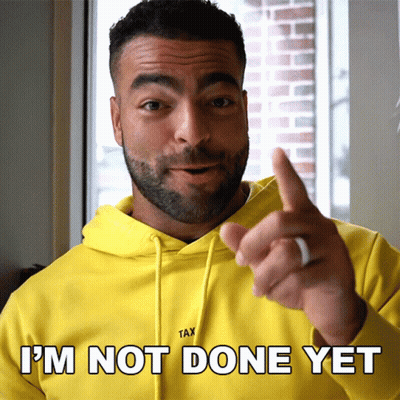 A Man In A Yellow Hoodie Says " I 'M Not Done Yet " While Pointing GIF