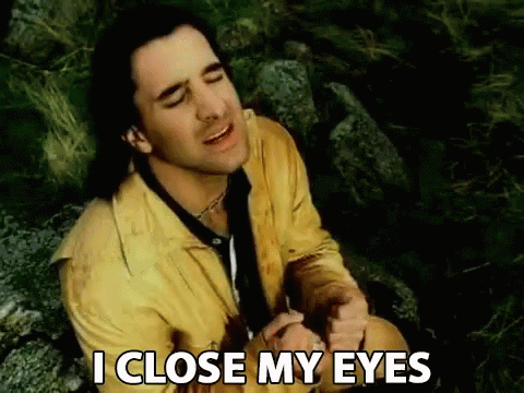 A Man In A Yellow Jacket And Tie Is Sitting On A Rock And Says I Close My Eyes GIF