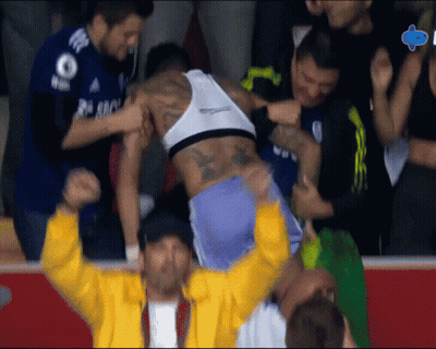 A Man In A Yellow Jacket Is Holding A Man In A White Tank Top With The Number 8 On It GIF