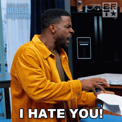 A Man In A Yellow Jacket Is Screaming And Holding A Piece Of Paper That Says I Hate You GIF