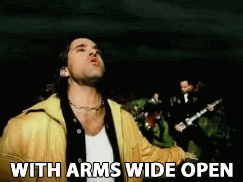 A Man In A Yellow Jacket Stands In Front Of A Group Of Men With The Words With Arms Wide Open Below Him GIF