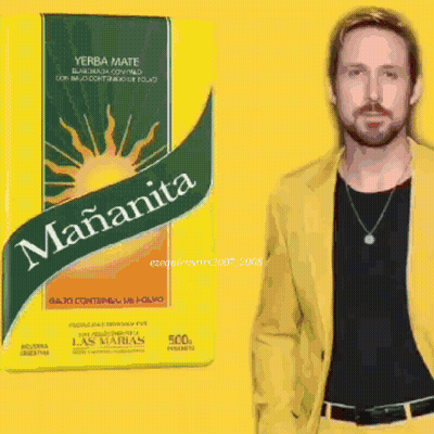 A Man In A Yellow Jacket Stands Next To A Box Of Yerba Mate GIF