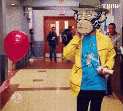 A Man In A Yellow Jacket With A Monkey On His Face Holding A Remote Control GIF