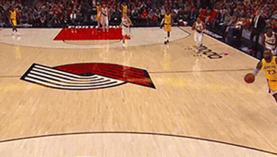 A Man In A Yellow Jersey With The Number 23 On It Dribbles A Basketball GIF