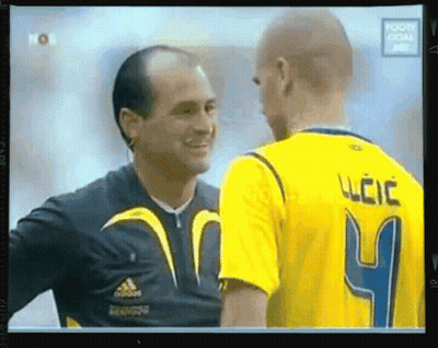 A Man In A Yellow Jersey With The Number 4 On It Is Talking To Another Man GIF