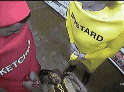 A Man In A Yellow Mustard Costume Holds A Mustard Bottle GIF