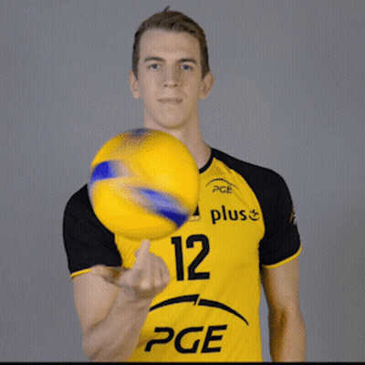 A Man In A Yellow Pge Shirt Holds A Yellow Ball GIF