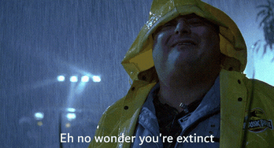 A Man In A Yellow Raincoat Says " Eh No Wonder You 'Re Extinct " In The Rain GIF