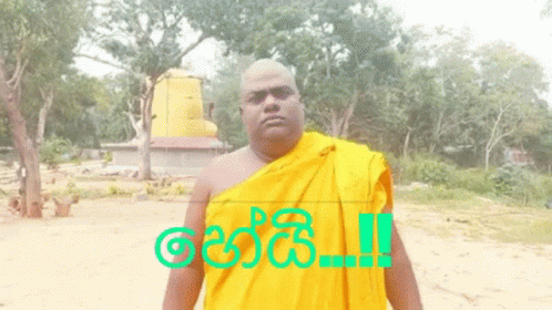 A Man In A Yellow Robe Is Standing In Front Of A Sign That Says " !! " GIF
