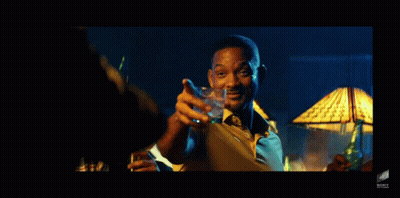 A Man In A Yellow Shirt And Tie Is Holding A Glass Of Water GIF