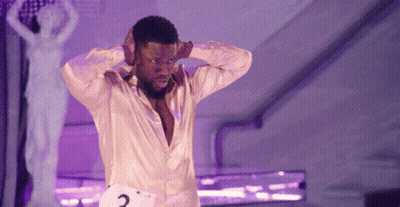 A Man In A Yellow Shirt Has A Number 2 On His Waist GIF
