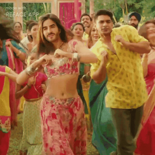 A Man In A Yellow Shirt Is Dancing With A Woman In A Pink Dress GIF