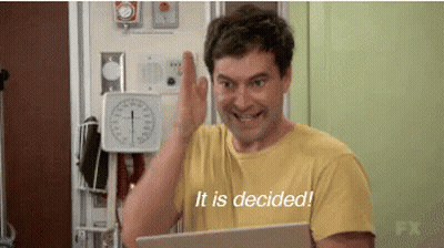 A Man In A Yellow Shirt Is Giving A High Five While Holding A Laptop And Says It Is Decided . GIF