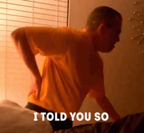 A Man In A Yellow Shirt Is Holding His Back With The Words I Told You So Written Below Him GIF