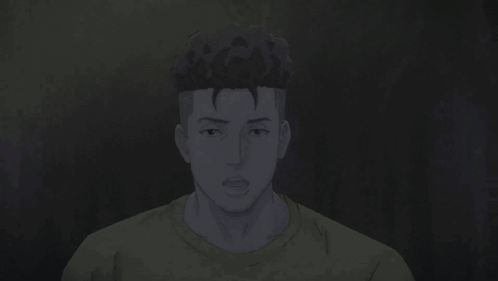 A Man In A Yellow Shirt Is Looking At The Camera With His Hands Folded . GIF