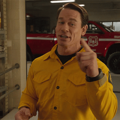 A Man In A Yellow Shirt Is Pointing At Something In Front Of A Red Truck That Says Usf GIF