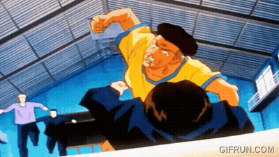 A Man In A Yellow Shirt Is Punching Another Man In A Room With A Gifrun.com Watermark GIF