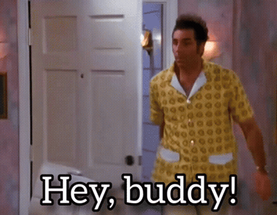 A Man In A Yellow Shirt Is Standing In Front Of A Door And Says Hey Buddy GIF