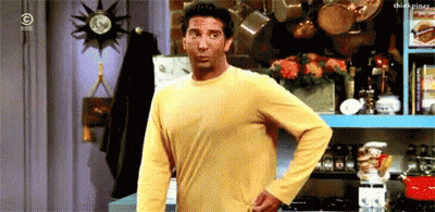 A Man In A Yellow Shirt Is Standing In Front Of A Kitchen GIF