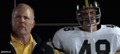 A Man In A Yellow Shirt Is Standing Next To A Football Player With The Number 19 On His Jersey GIF