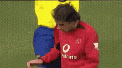 A Man In A Yellow Shirt Is Standing Next To A Man In A Red Shirt . GIF
