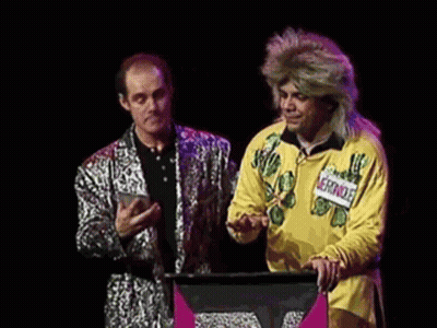 A Man In A Yellow Shirt Is Standing Next To A Man In A Silver Suit And Says " Vous Pouvez Repeter La Question " GIF