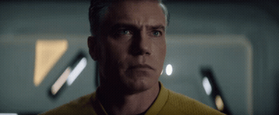 A Man In A Yellow Shirt Looks At The Camera With A Serious Look On His Face GIF