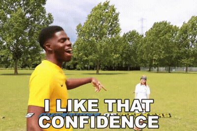 A Man In A Yellow Shirt Says I Like That Confidence In A Park GIF