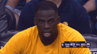 A Man In A Yellow Shirt Sits In The Stands Watching A Game Between Gsw And Okc GIF
