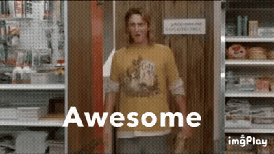 A Man In A Yellow Shirt Standing In Front Of A Sign That Says Awesome GIF