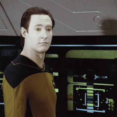 A Man In A Yellow Shirt Stands In Front Of A Screen That Says Science GIF