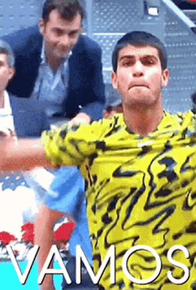 A Man In A Yellow Shirt With The Word Vamos On The Bottom GIF