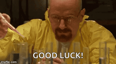 A Man In A Yellow Suit Is Holding A Pipette And Saying Good Luck GIF