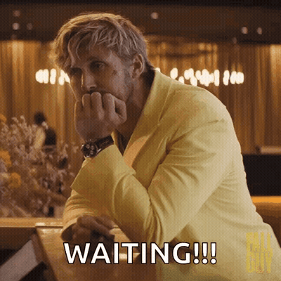 A Man In A Yellow Suit Is Sitting At A Table And Waiting !!! GIF