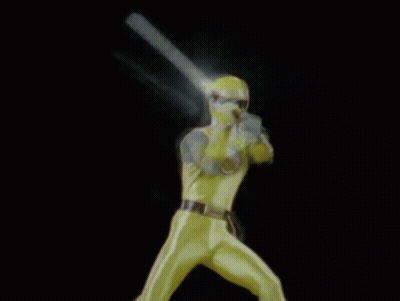 A Man In A Yellow Superhero Costume Is Holding A Light In His Hand . GIF