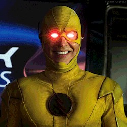 A Man In A Yellow Superhero Suit Has Red Eyes GIF