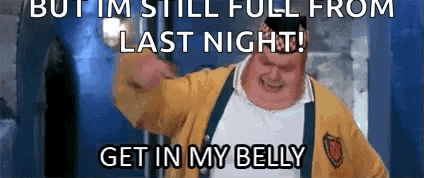 A Man In A Yellow Sweater And Suspenders Is Making A Funny Face With The Words But Im Still Full From Last Night GIF