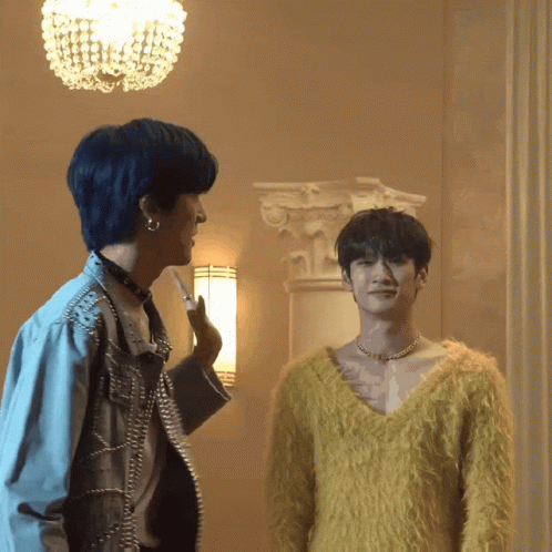 A Man In A Yellow Sweater Is Standing Next To A Man In A Blue Jacket GIF