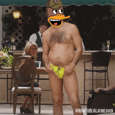 A Man In A Yellow Swim Suit With A Cartoon Duck On His Head GIF