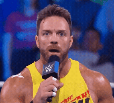 A Man In A Yellow Tank Top Is Holding A Microphone With A W On It GIF