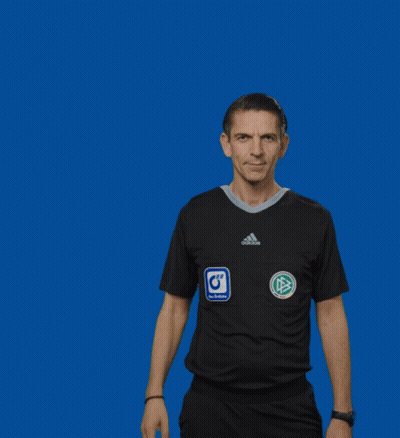 a man in an adidas shirt holds up a yellow card against a blue background
