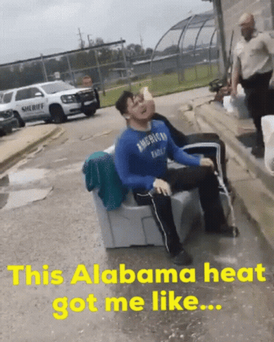 A Man In An American Eagle Shirt Is Sitting On A Couch In The Rain GIF