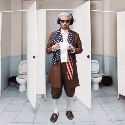 A Man In An American Flag Costume Is Standing In A Bathroom Holding A Roll Of Toilet Paper GIF