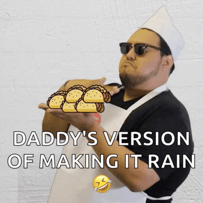 A Man In An Apron Is Holding A Bunch Of Tacos And The Caption Says Daddy 'S Version Of Making It Rain GIF