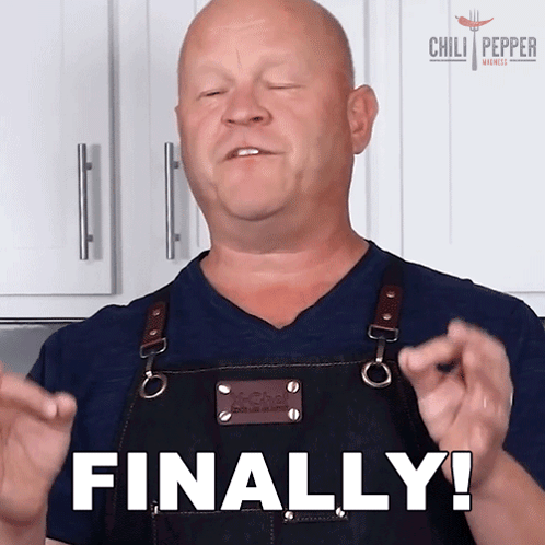 A Man In An Apron Says Finally With His Hands In The Air GIF