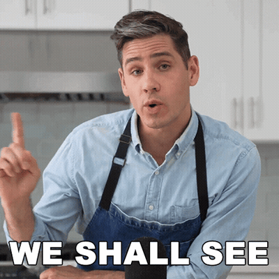 A Man In An Apron Says " We Shall See " In A Kitchen GIF